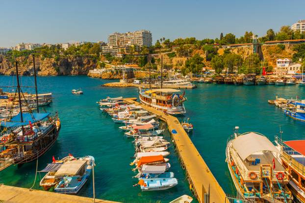 ANTALYA, TURKEY: Sailing ships and boats on the waves of the Antalya port on a sunny summer day.