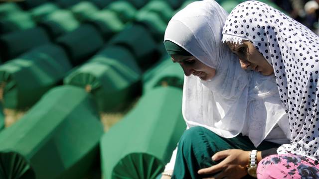 FILE PHOTO: Muslim women cry near coffins of their relatives, who are newly identified victims of the 1995 Srebrenica massacre, which are lined up for a joint burial in Potocari near Srebrenica