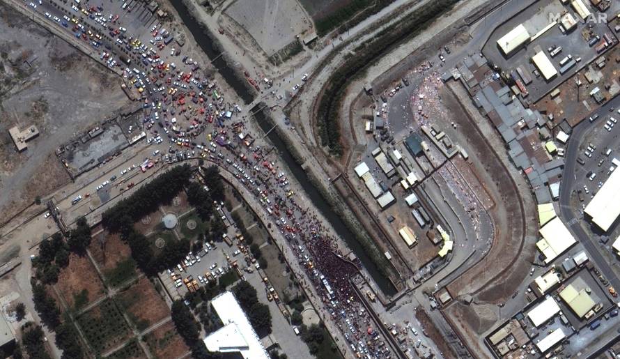 An overview of crowds at a gate to Kabul's airport