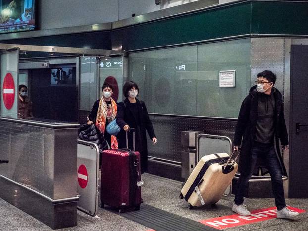 People arrive at Malpensa airport with airplanes from China passengers wear masks after checks performed by the taskforce that monitors the Wuhan Corona Virus