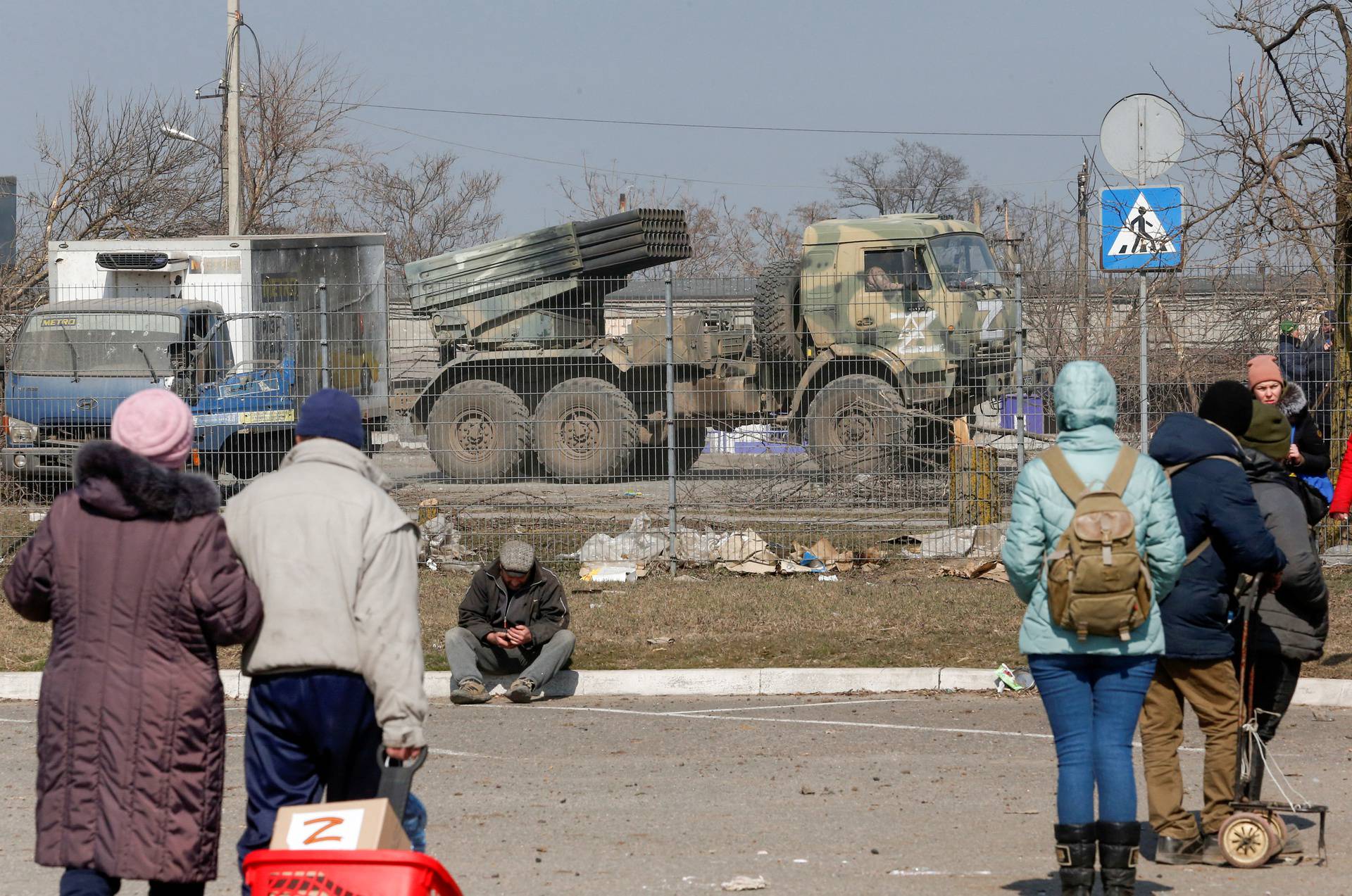 Service members of pro-Russian troops drive a multiple rocket launcher in the besieged city of Mariupol