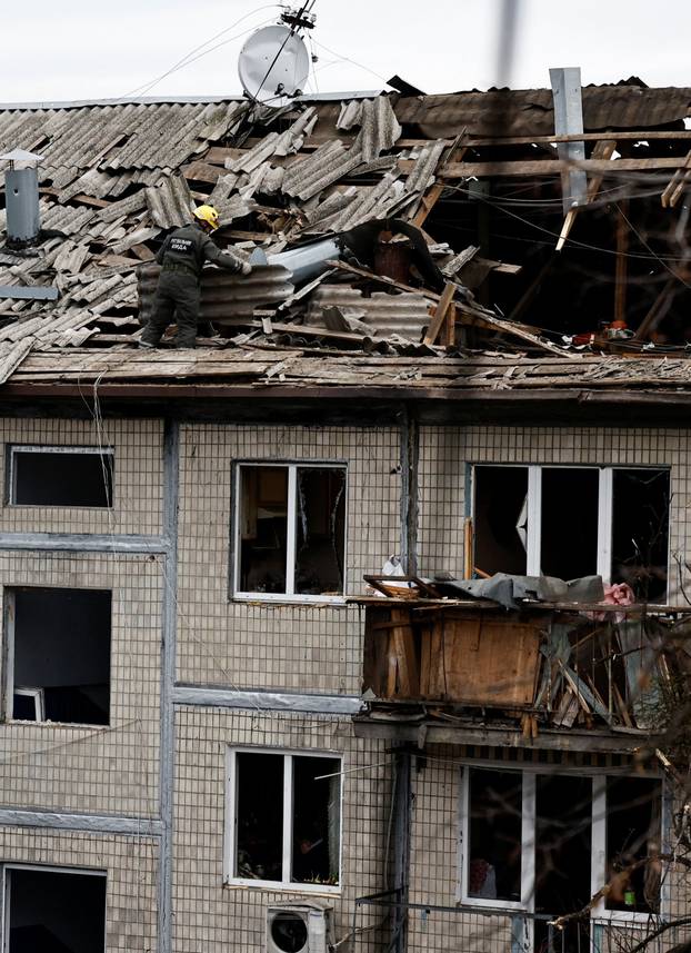 Emergency responders work at the site of a Russian drone strike on an apartment building, in Kyiv
