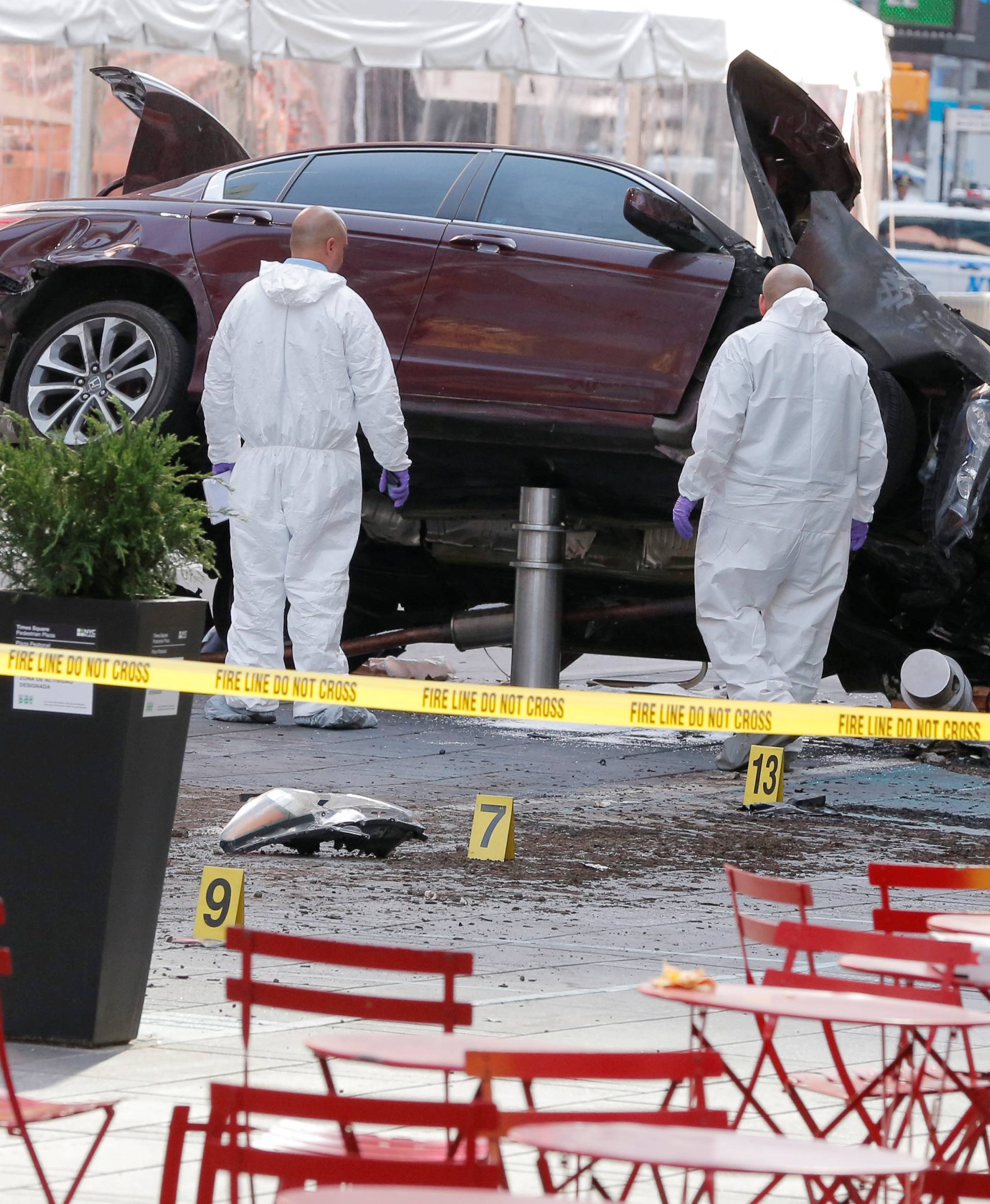 Emergency personnel inspect a vehicle involved in striking a number of pedestrians in Times Square in New York