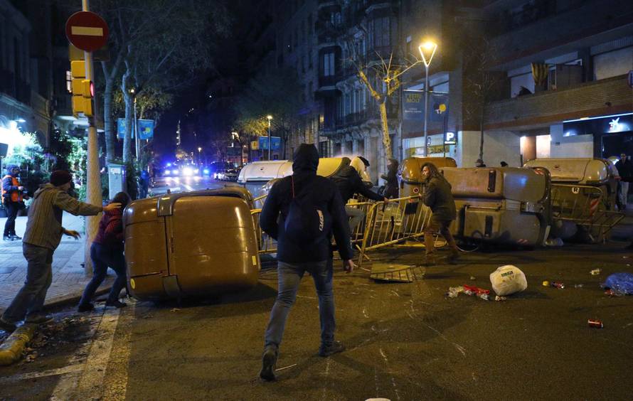 Protestors erect barricades on a street during skirmishes with police after former regional president Carles Puigdemont was detained in Germany,  in Barcelona