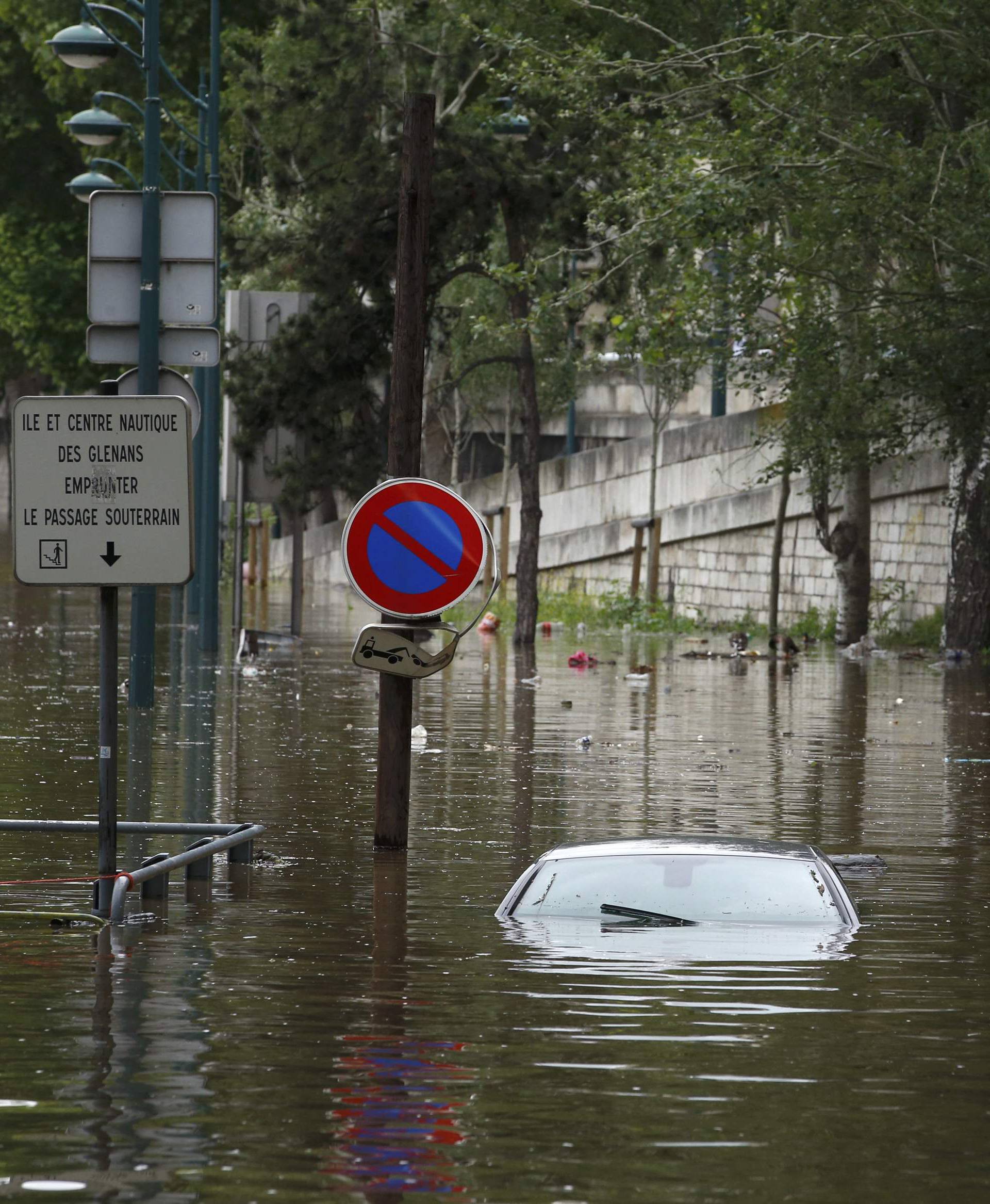 An abandoned car is submerged in deep water on the flooded river-side of the River Seine in Paris