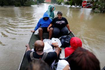 Hawkins family is rescued from the flood waters of Tropical Storm Harvey in Beaumont Place, Houston