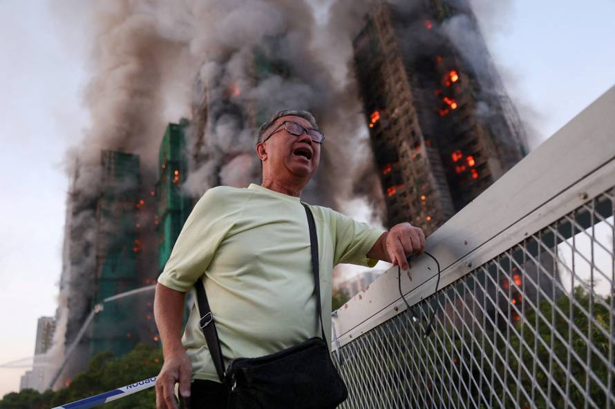 Flames engulf bamboo scaffolding across multiple buildings at Wang Fuk Court housing estate, in Tai Po