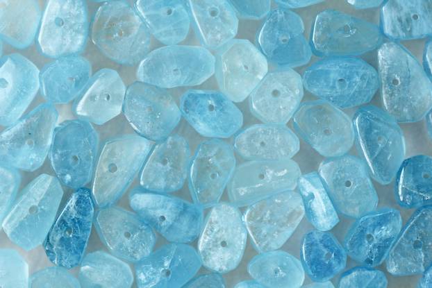 Aquamarine is blue. Natural stone is blue aquamarine. The backgr