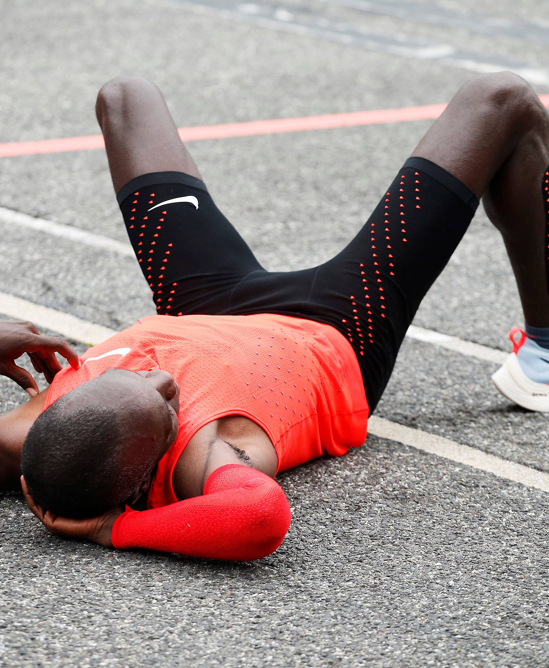 Kipchoge reacts after crossing  the finish line during an attempt to break the two-hour marathon barrier at the Monza circuit.