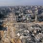 Displaced Palestinians walk past the rubble as they attempt to return to their homes, in the northern Gaza Strip