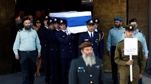 Members of the Knesset guard carry the flag-draped coffin of former Israeli President Shimon Peres, during a ceremony at the Knesset, Israeli Parliament, before it is transported to Mount Herzl Cemetery ahead of his funeral in Jerusalem 