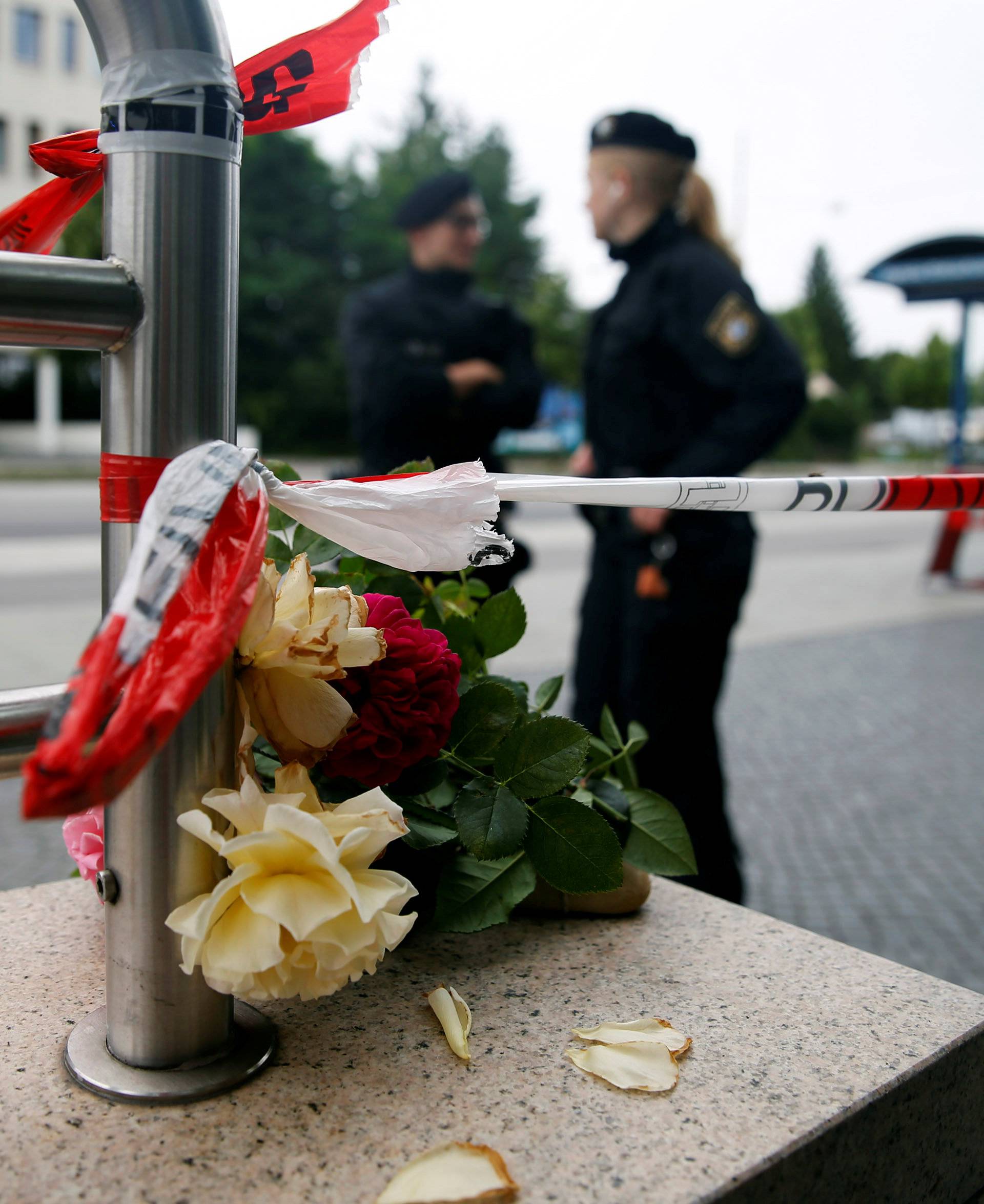 Flowers are placed near the Olympia shopping mall, where yesterday's shooting rampage started, in Munich