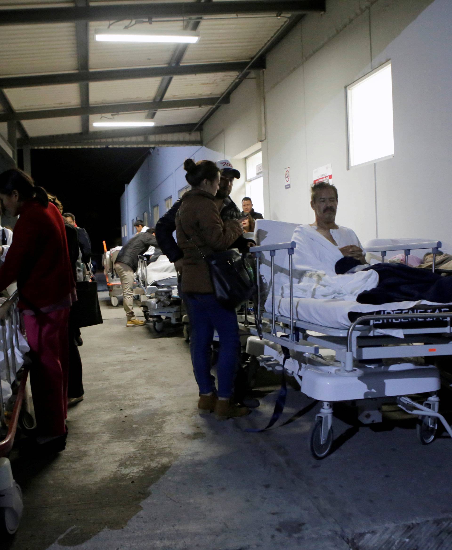Patients and family members are seen outside the ISSSTE after an earthquake struck off the southern coast of Mexico late on Thursday, in Puebla