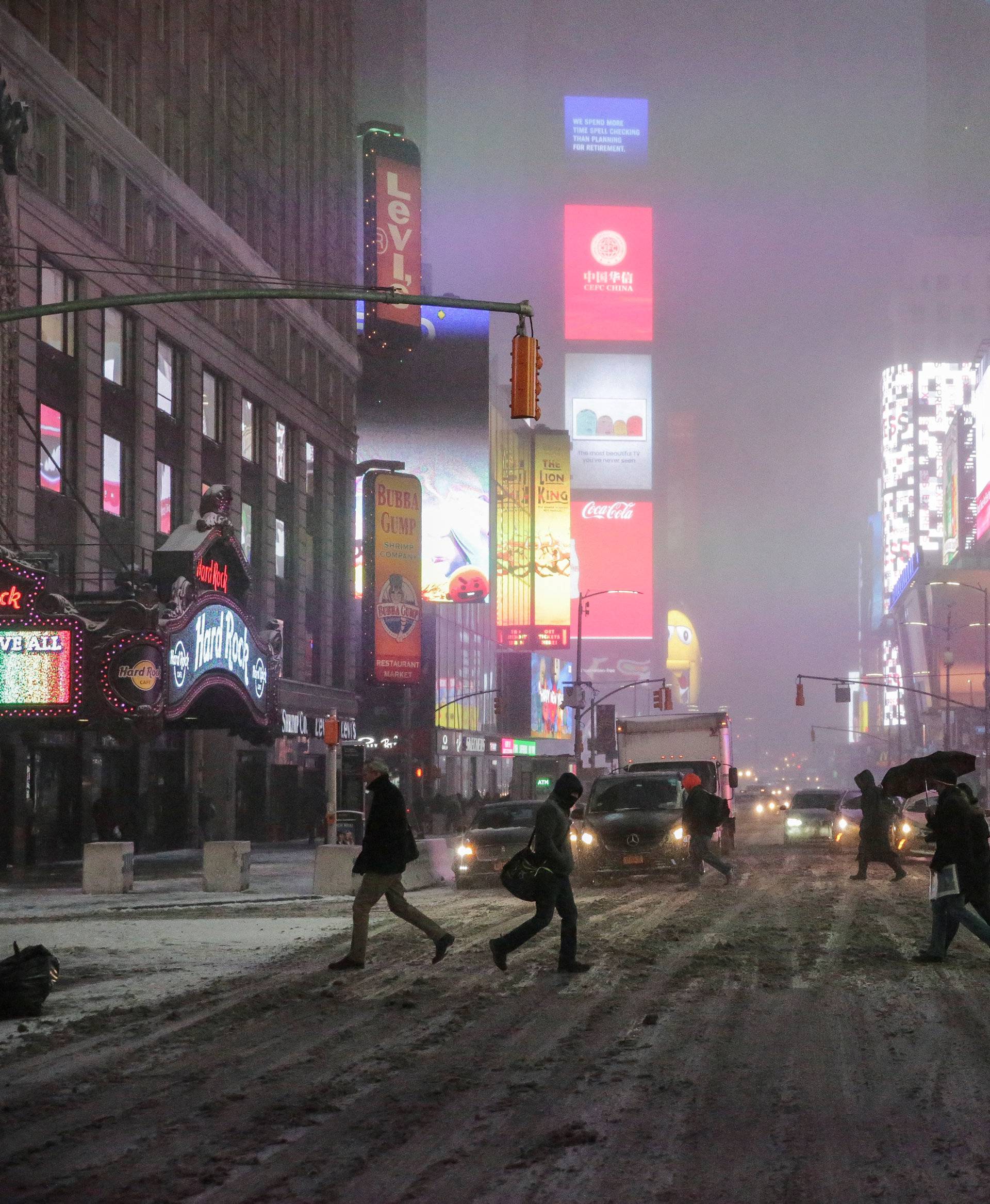 People walk in Times Square during a winter storm in Manhattan