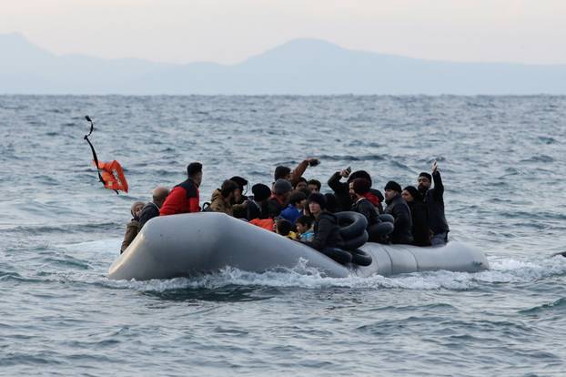 Migrants from Syria, Iraq, Afghanistan and Palestinian territories arrive on a dinghy near the city of Mytilene, after crossing part of the Aegean Sea from Turkey to the island of Lesbos