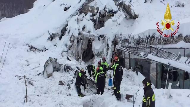 A photo taken from a video shows firefighters work at Hotel Rigopiano in Farindola