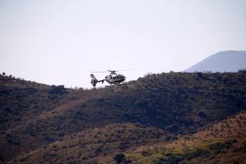 A Spanish Civil Guard helicopter lands carrying boxes with explosives picked in Sevilla at the area where Julen, a Spanish two-year-old boy, fell into a deep well, in Totalan