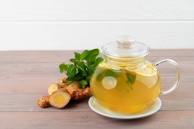 Glass teapot of tea with ginger and citrus