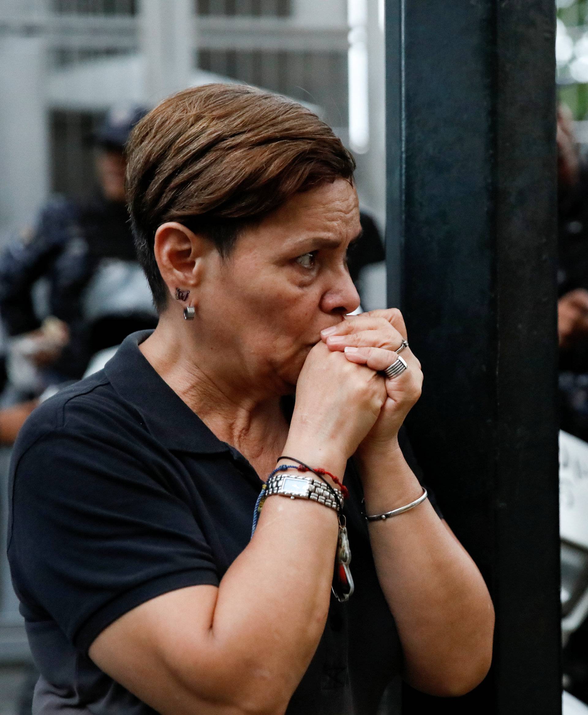 A mourner of the municipal lawmaker Fernando Alban reacts outside the headquarters of Bolivarian National Intelligence Service (SEBIN) in Caracas