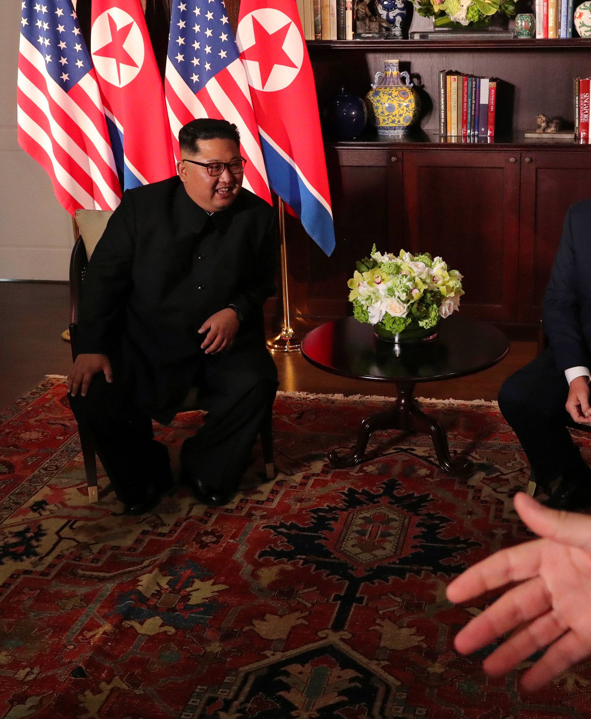 U.S. President Donald Trump and North Korea's leader Kim Jong Un smile before their meeting in Singapore