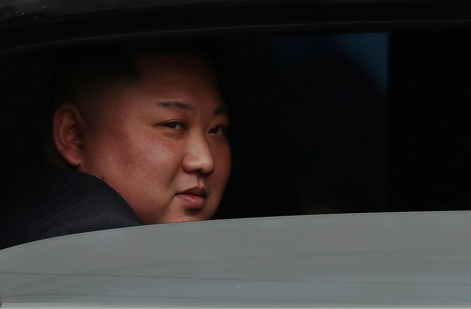 North Korea's leader Kim Jong Un sits in his vehicle after arriving at the Dong Dang railway station