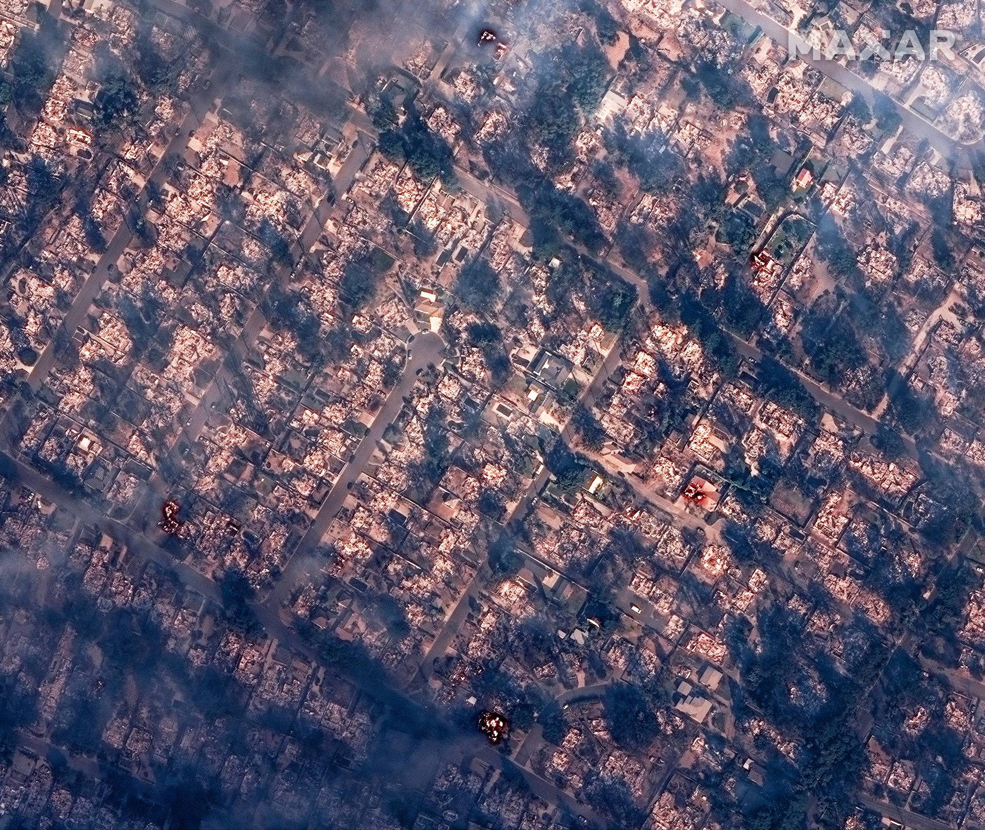 A satellite image shows smoke covering houses after devastating wildfires, in Altadena