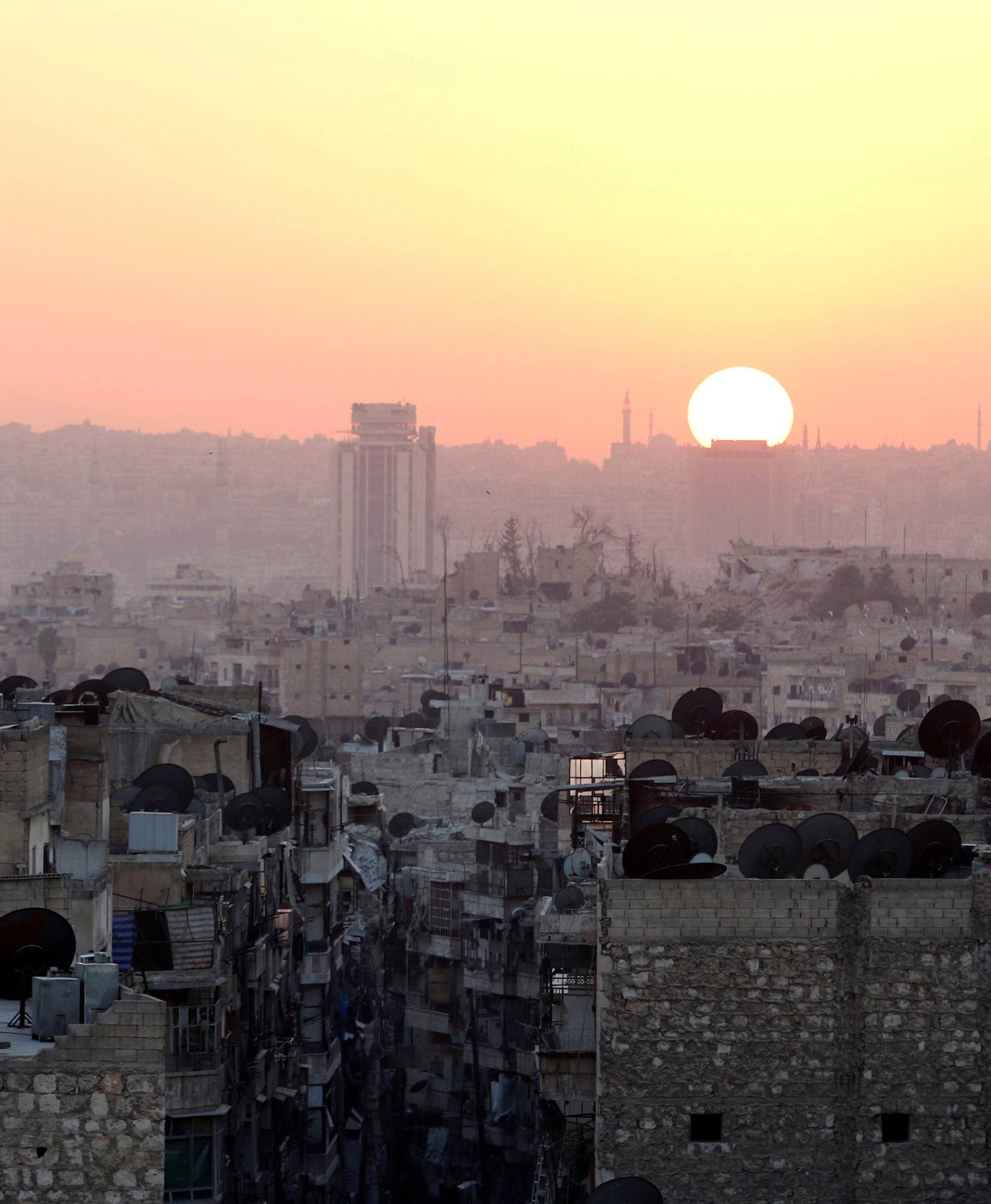 FILE PHOTO: The sun sets over Aleppo as seen from rebel-held part of the city
