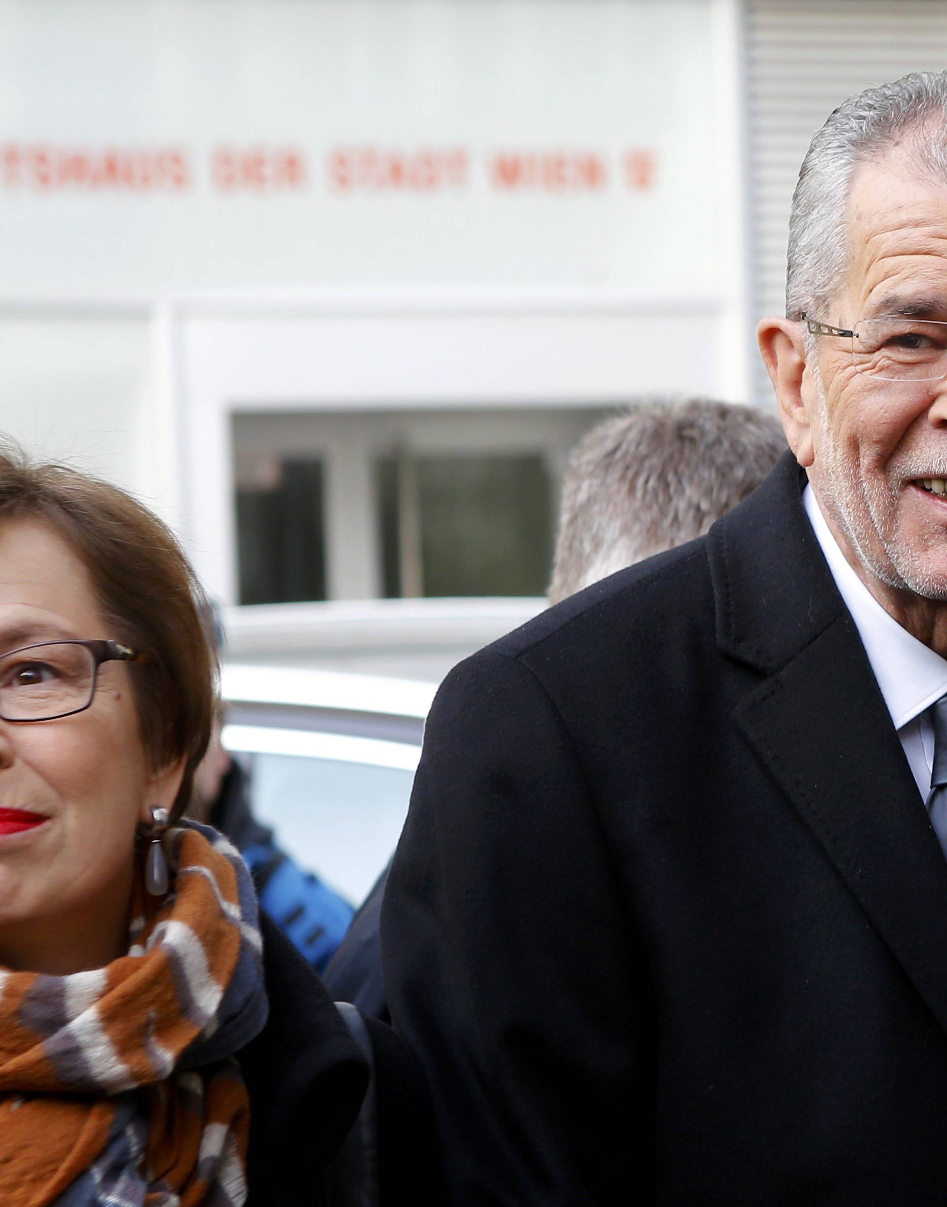 Austrian presidential candidate Van der Bellen, who is supported by the Greens, and his wife Schmidauer arrive in front of a polling station to cast their vote in Vienna
