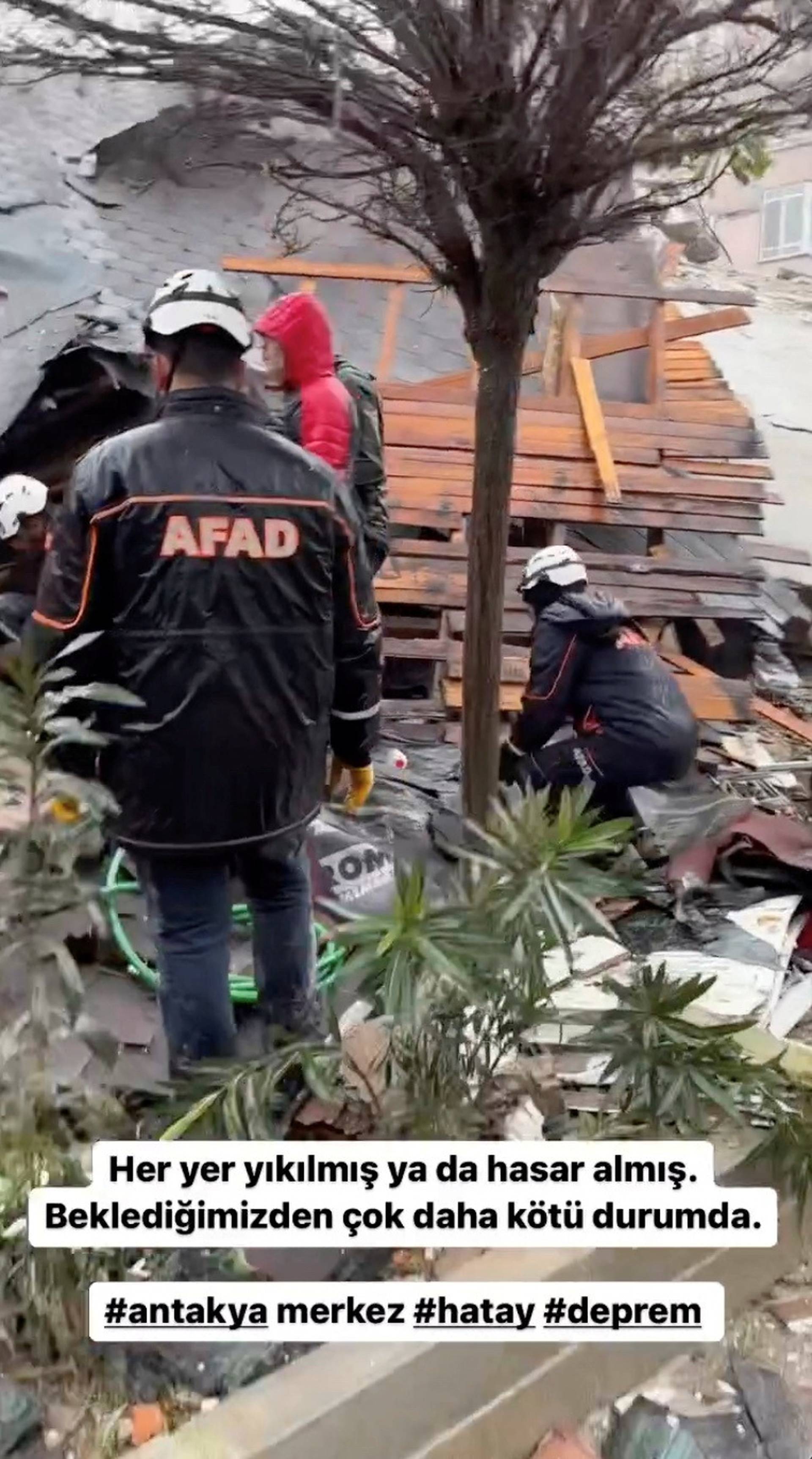 Rescuers search for survivors at the site of a collapsed building following an earthquake in Hatay