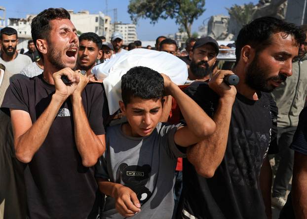 Mourners attend the funeral of Palestinians killed in overnight Israeli airstrikes, in Gaza City