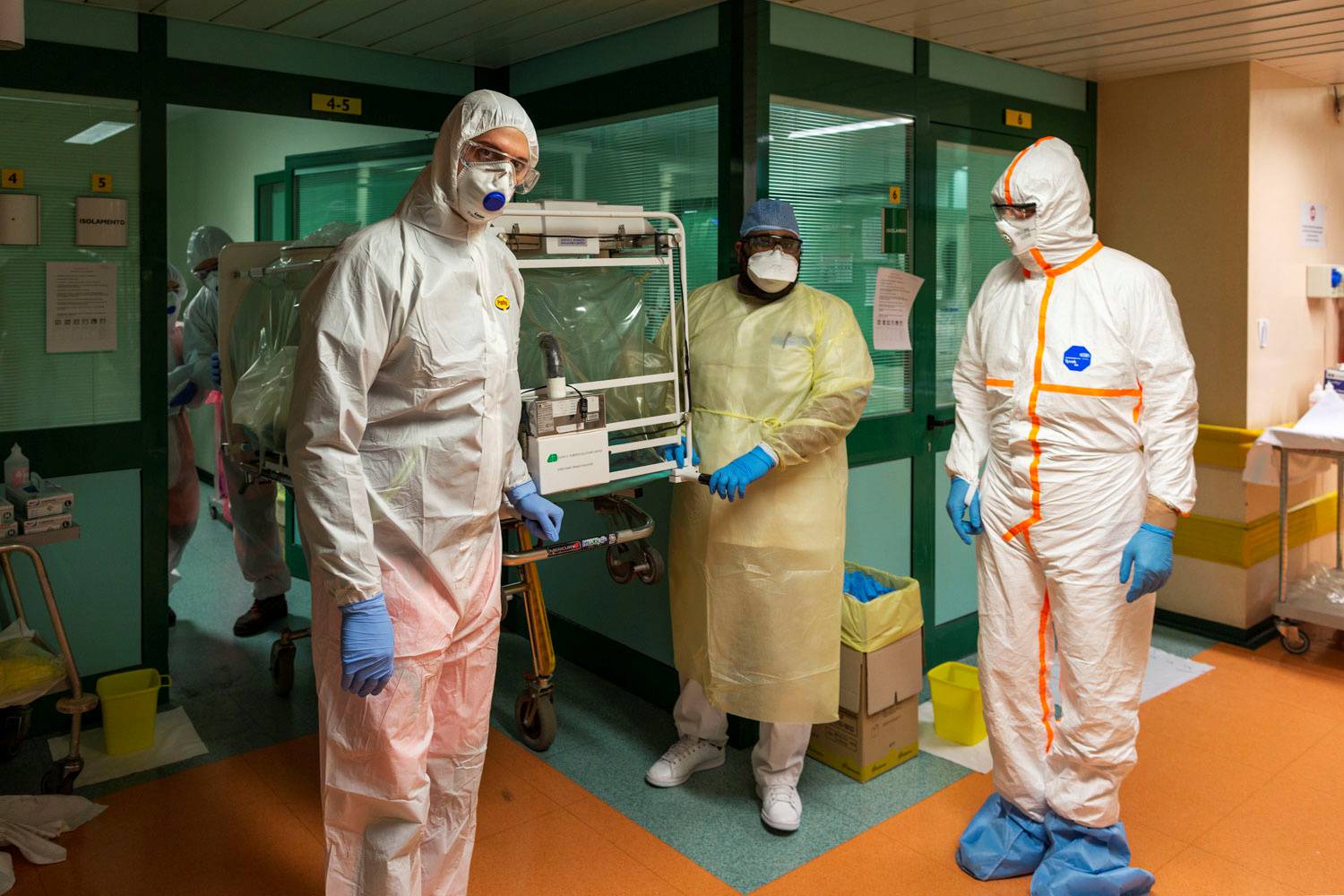 Medical workers in protective suits transfer a coronavirus patient from the intensive care unit of the Gemelli Hospital to the Columbus Covid Hospital, in Rome