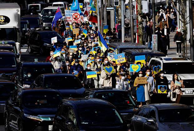 Protesters wearing protective masks, amid the coronavirus disease (COVID-19) outbreak, participate in a march to protest against Russia's invasion of Ukraine, in Tokyo