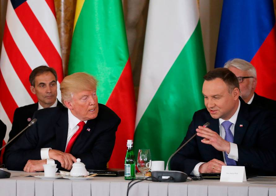 U.S. President Donald Trump talks to Polish President Andrzej Duda during the Three Seas Initiative Summit in Warsaw