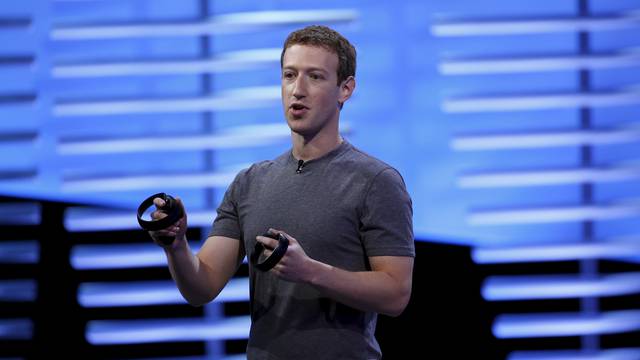 Facebook CEO Mark Zuckerberg holds a pair of the touch controllers for the Oculus Rift virtual reality headsets during the Facebook F8 conference in San Francisco, California