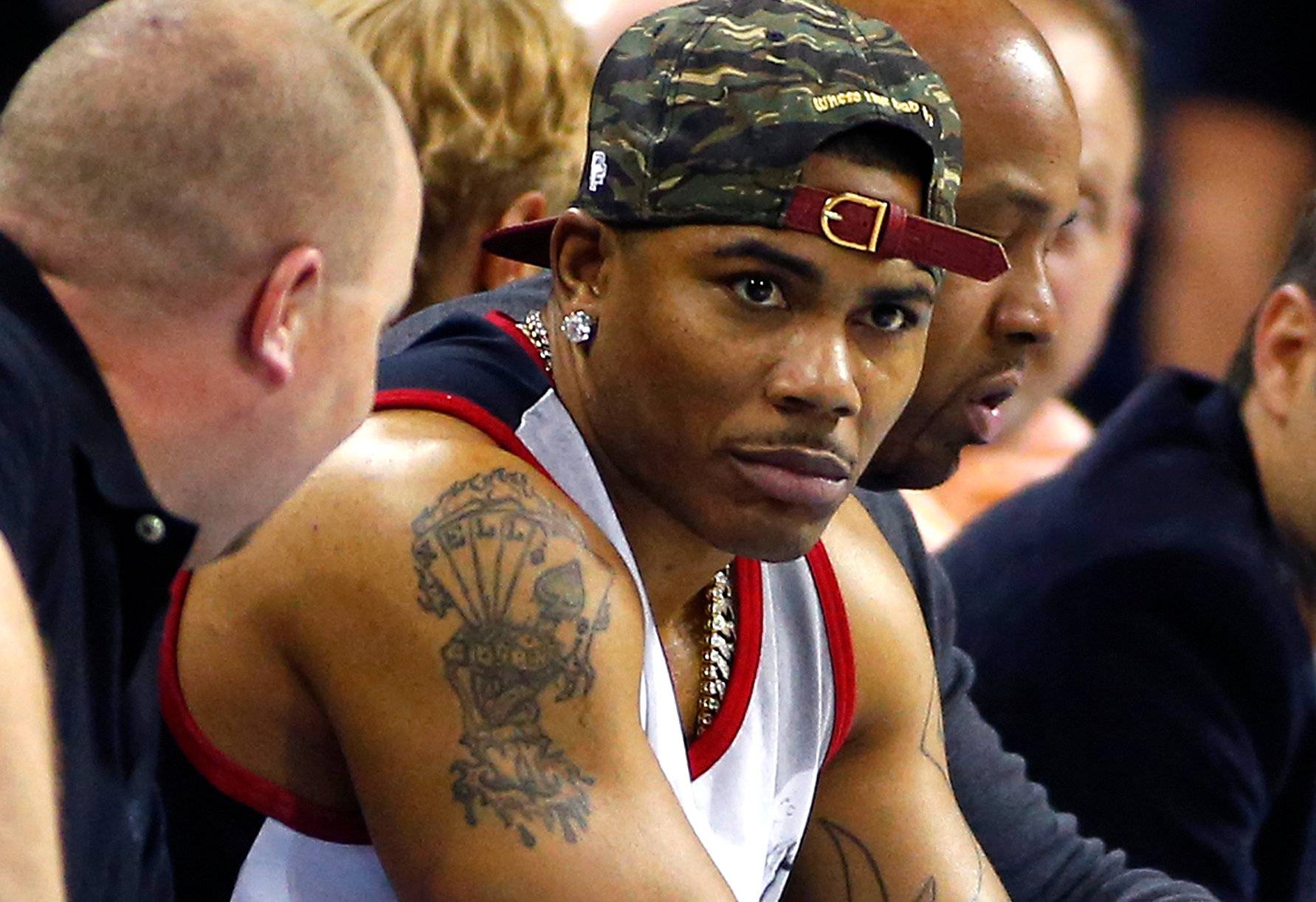 FILE PHOTO: Recording artist Nelly watches the game between the New York Knicks and the Charlotte Bobcats during an NBA basketball game in Charlotte