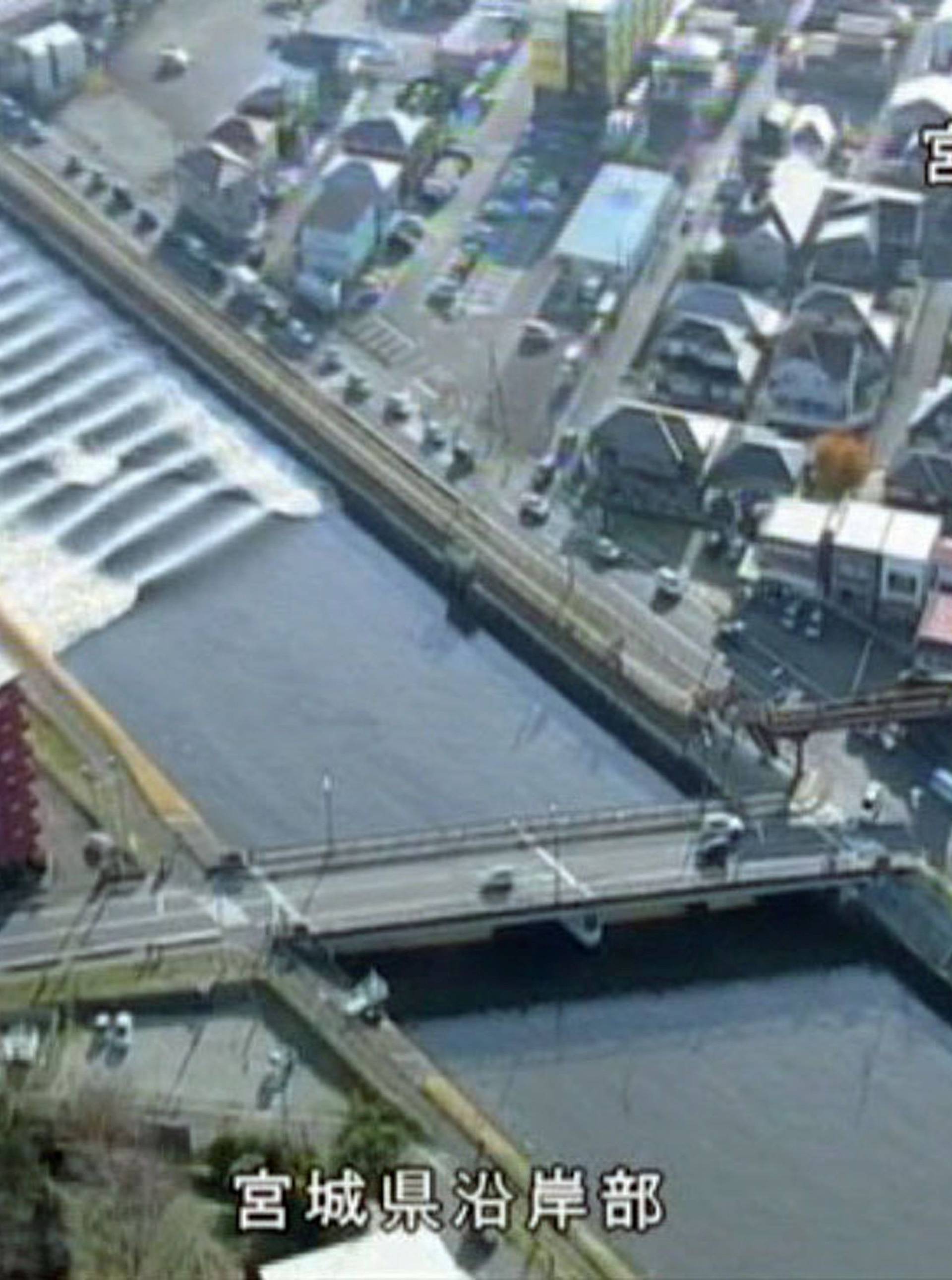 A tidal surge is seen in Sunaoshi River after tsunami advisories were issued following an earthquake in Tagajo, Miyagi prefecture