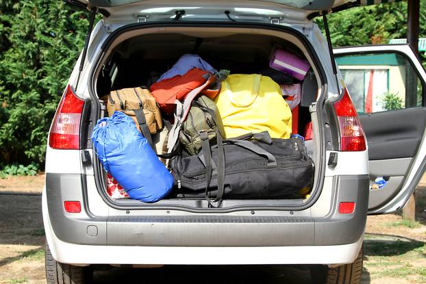 car with the trunk full of luggage and suitcases for the summer 