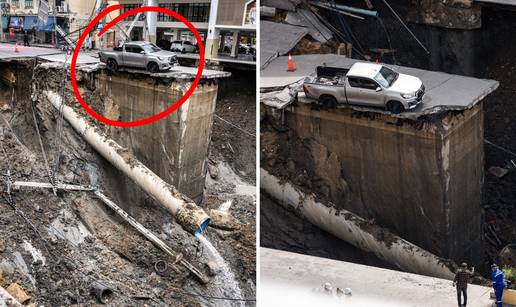 FOTO Je li ovo najsretniji čovjek na svijetu? Tajfun uništio cestu, auto ostao na rubu kratera!