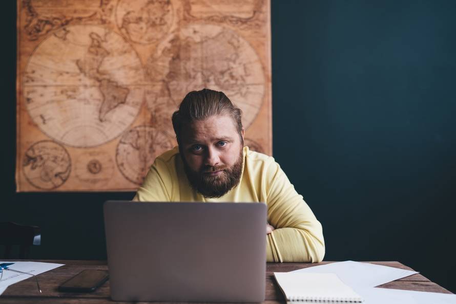 Man,Stares,Blankly,At,Screen,With,Distant,Eyes,,Frozen,In