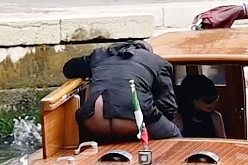 *PREMIUM-EXCLUSIVE* *MUST CALL FOR PRICING* Kanye West has a wardrobe malfunction as his rear end is on show to passing tourists as he takes a river taxi with his wife Bianca Censori on Venice's canal
