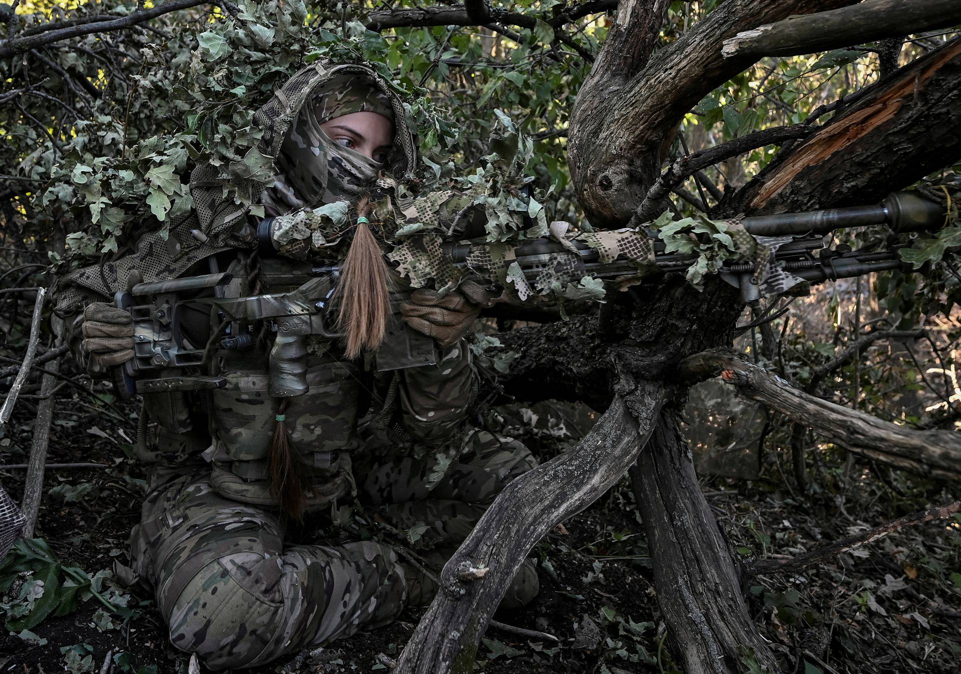 FILE PHOTO: A sniper of Ukraine's 3rd Separate Assault Brigade takes a position during a reconnaissance mission near Bakhmut