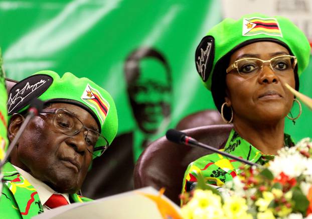 Zimbabwean President Robert Mugabe and his wife Grace attend a meeting of his ruling ZANU PF party