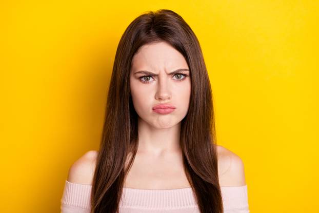 Photo of sad brunette lady wear pink shirt isolated on yellow color background