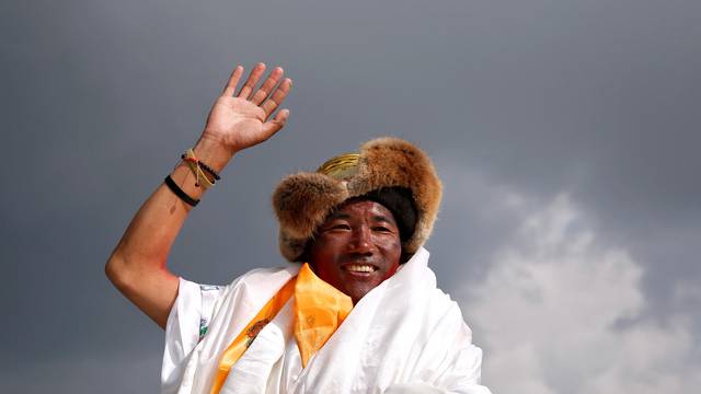 FILE PHOTO: Kami Rita Sherpa, 48, a Nepali mountaineer waves towards the media personnel upon his arrival after climbing Mount Everest for a 22nd time, creating a new record for the most summits of the worldÃs highest mountain, in Kathmandu