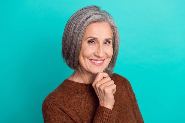 Photo of pretty lovely lady toothy smile arm face wear knitted clothes isolated on cyan color background