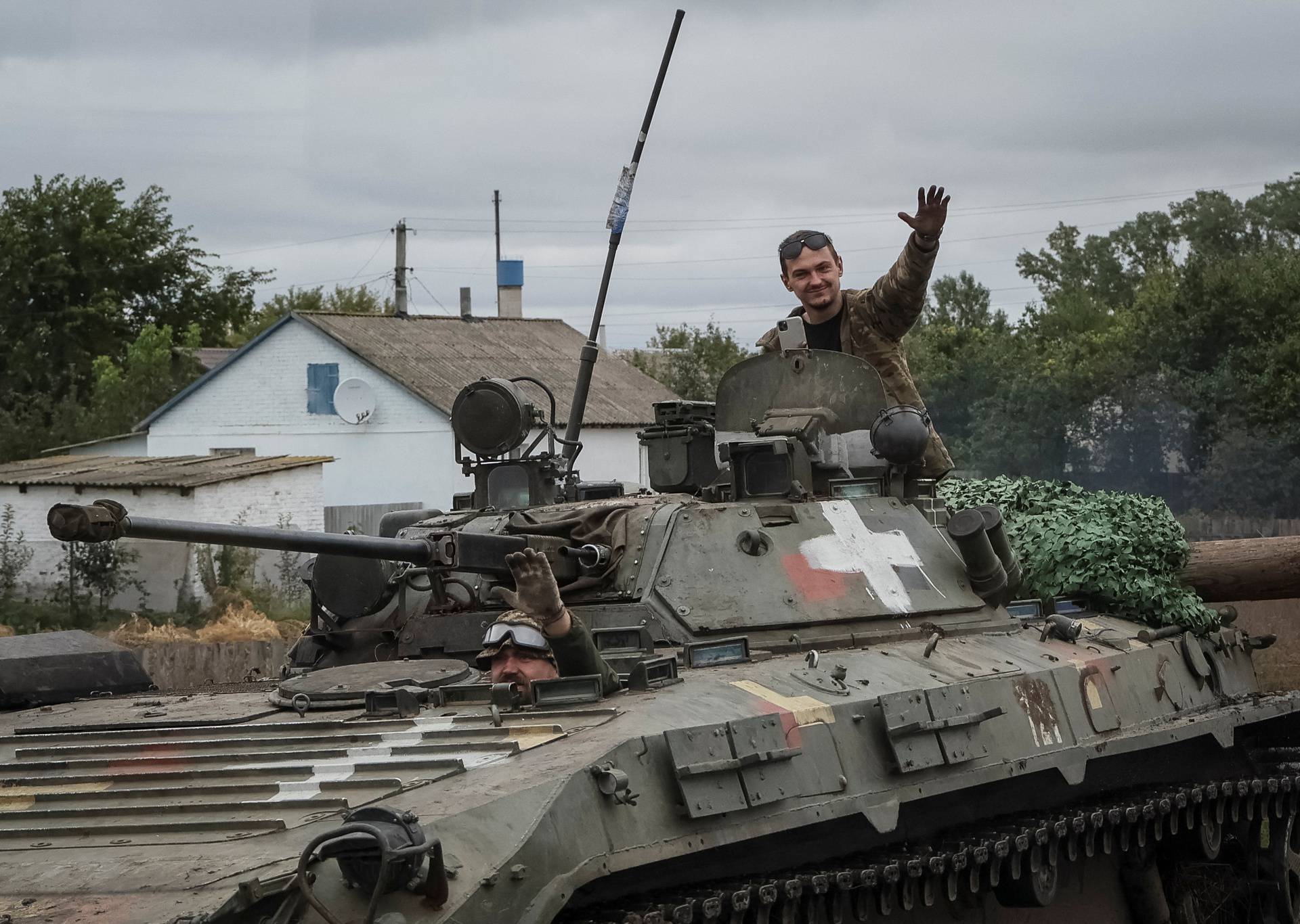 Ukrainian service members ride a BMP-2 infantry fighting vehicle in Kharkiv region