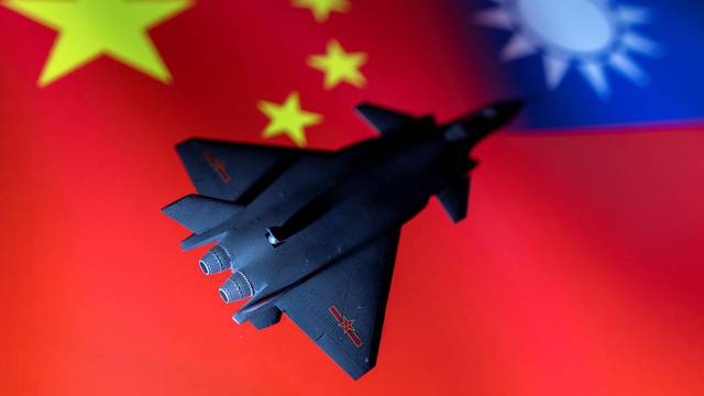 FILE PHOTO: Illustration shows model of Chinese Fighter in front of Chinese and Taiwanese flags