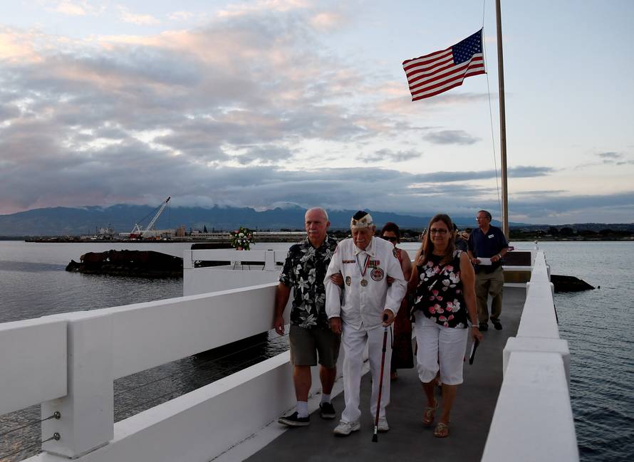 Pearl Harbor survivor Delton Walling walks with family members during a ceremony honoring the sailors of the USS Utah at the memorial on Ford Island at Pearl Harbor in Honolulu, Hawaii