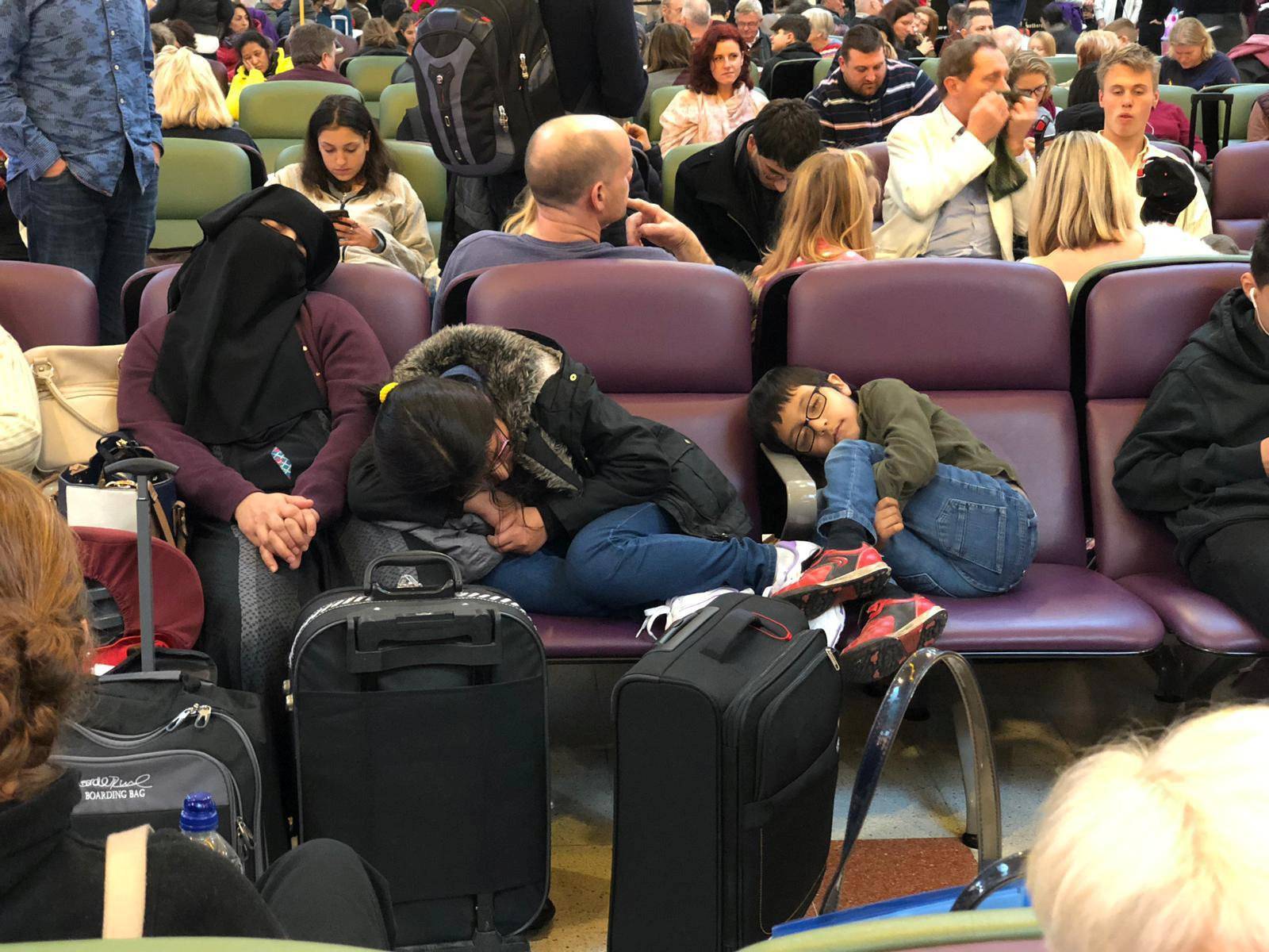 Stranded passengers are seen sleeping at Gatwick Airport