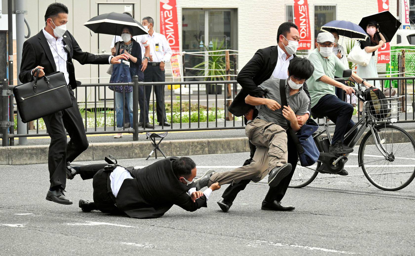 A man, believed to have shot former Japanese Prime Minister Shinzo Abe, is tackled by police officers in Nara, western Japan